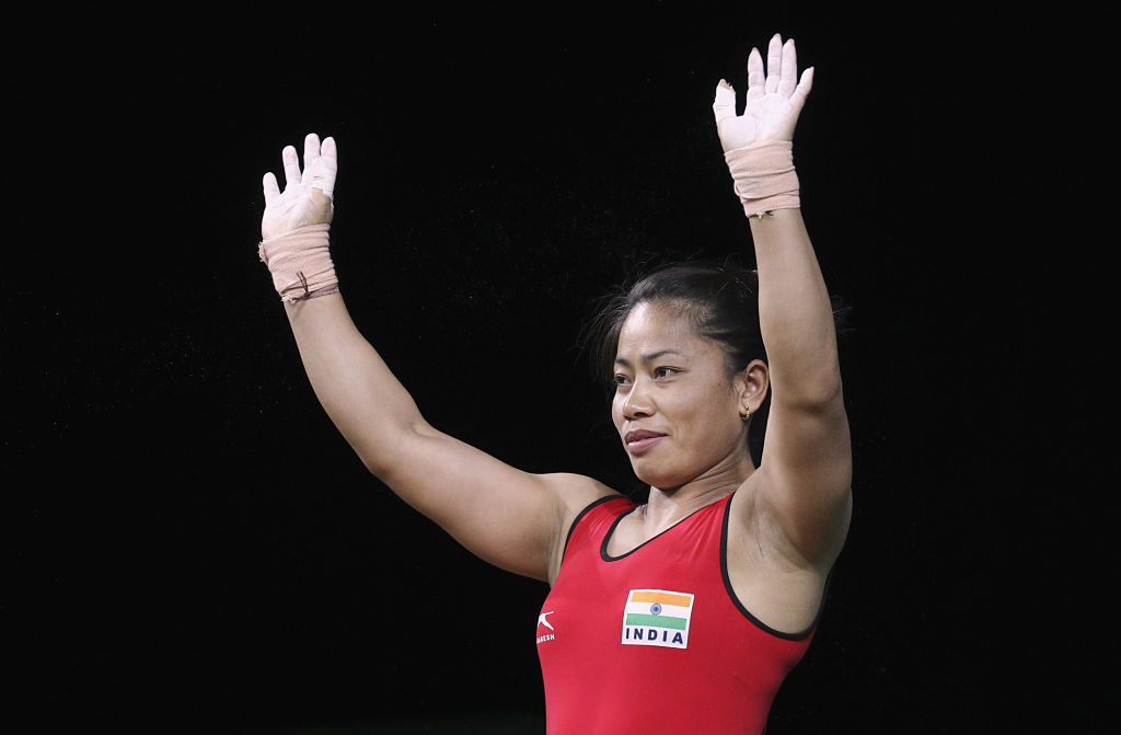 Weightlifting -Sanjita Chanu Khumukcham of India waves after winning Gold Medal